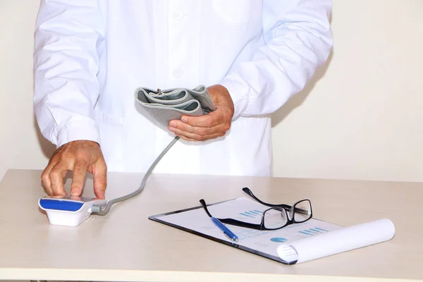 Close-up - doctor measures blood pressure