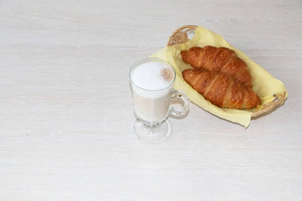 Close-up - breakfast, a cup of cappuccino coffee and croissants. — Stock Photo, Image