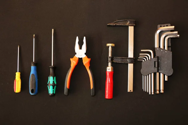 A set of new hand tools on a black background. A set of a new hand tool on an advertising billboard. The background is black.