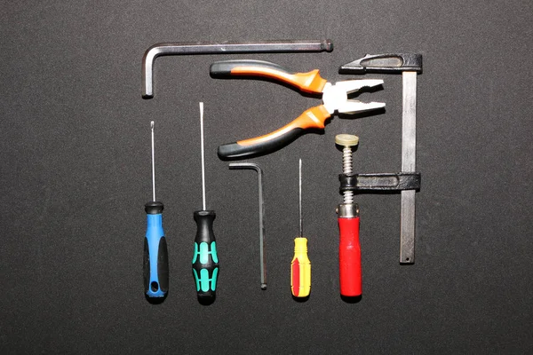 A set of new hand tools on a black background. A set of a new hand tool on an advertising billboard. The background is black.