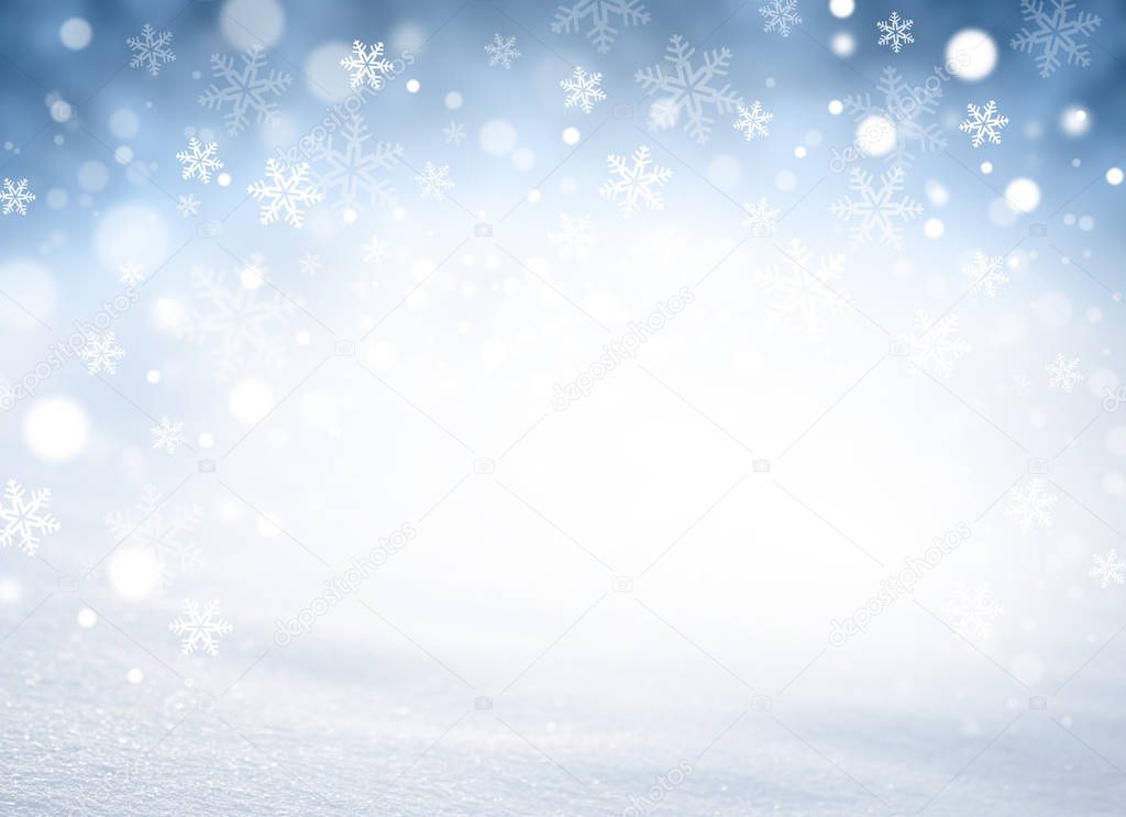 Snowflakes and snowfall on a blue iced winter background
