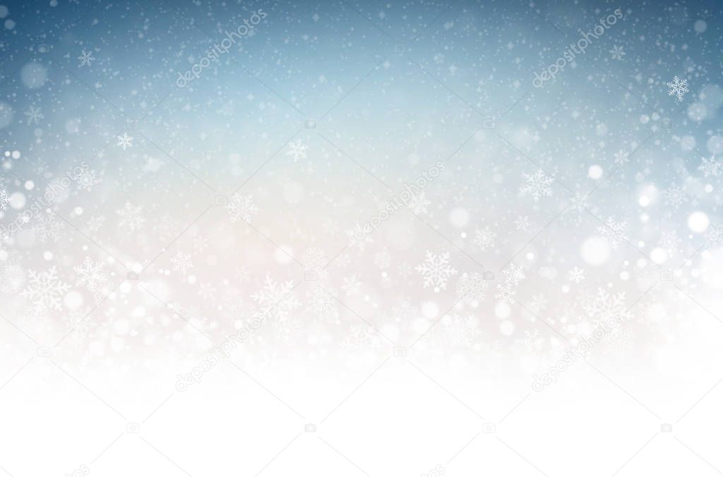 Snowflakes and snowfall on a cold blue winter background