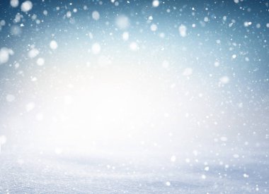Snowflakes and snowfall exploding on a white snow covered ground and blue iced background. Winter seasonal material. clipart