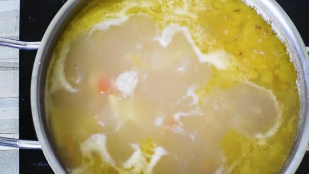 Boiling fish soup in a stainless steel pan that stands on the built-in stove. Fish soup with canned fish. Lunch or light dinner top View — Stock Footage Boiling Fish Soup Stainless Steel Pan Stands Built Stove Fish Stock Video