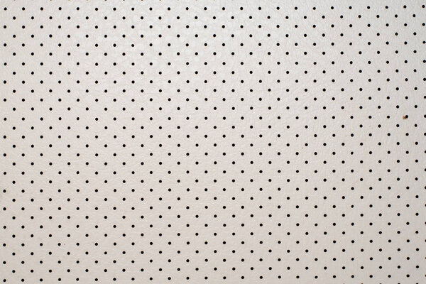 Background, perforated ivory leather, interior decoration of old retro car Backgrounds and textures from leather in white with a perforation