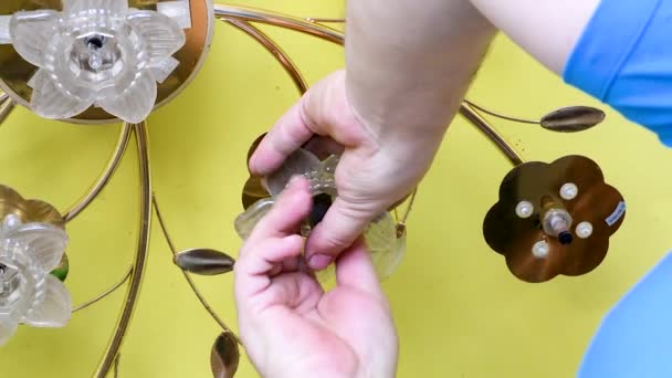 Man Unscrews Ceiling Light Chandelier Special Key Yellow Stretch Ceiling — Stock Video