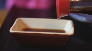 Soya sosu. Soya sosu bir kap içine dökülür
