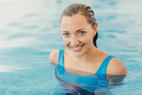 A girl in a swimsuit against the backdrop of the pool — Stock Photo, Image