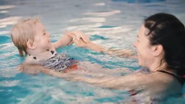 Vídeo Clipe Mãe Ensina Uma Criança Nadar Piscina — Vídeo de Stock