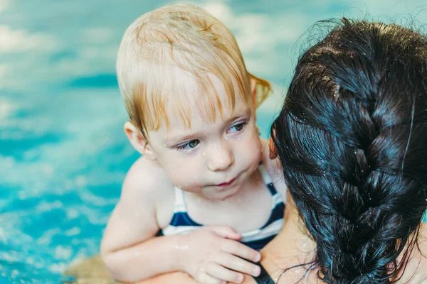 Piscina. Mamá enseña a un niño pequeño a nadar en la piscina . —  Fotos de Stock