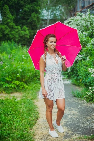 Umbrella. Young woman with an umbrella from the rain.