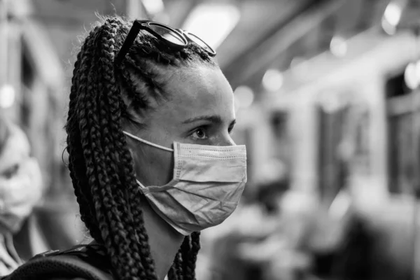 Medical mask. A woman in a medical mask rides on public transport.