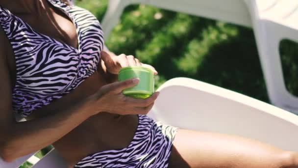 Tan Woman Swimsuit Smears Sunscreen — Stock Video