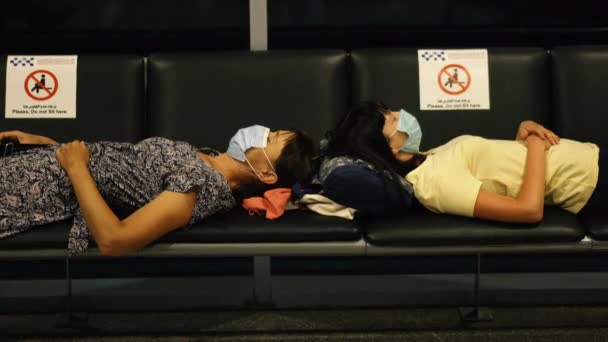 Virus Two Women Medical Masks Lie Benches Airport While Waiting — Stock Video