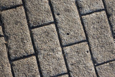Bir kaldırım taşı dokusunun kapanışı kaldırım taşı yolu oluşturuyor, arka plan ve dokular için ideal.