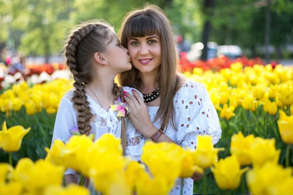 Happy daughter kisses mom — Stock Photo, Image