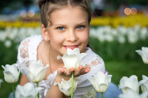 Красива дівчина нюхає тюльпан на відкритому повітрі — стокове фото