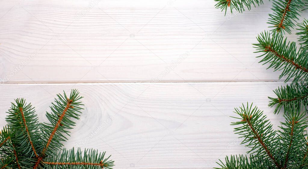 Christmas fir tree on a white wooden board and copy space for your text. Banner.Flat lay