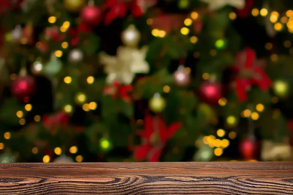 Noel arkaplanı. Noel ağacı ve yılbaşı ağacının arka planında boş ahşap masa. Ürün montajı için hazır.