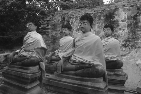 Buddha images in meditation pose in the Wat Phutthaisawan ruins in Ayutthaya, Thailand.