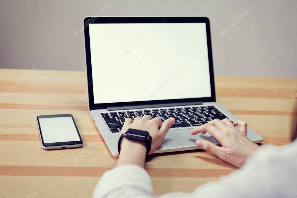 woman using laptop on table in office room, for graphics display montage. Take your screen to put on advertising.