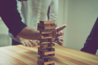 kadın ve bir piramit boş tahta küpleri ile yapım çalışması. İş kavramı ile bir firma olarak için adım adım.