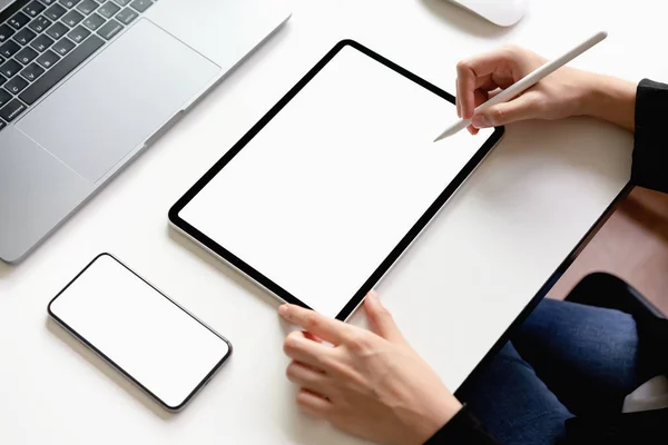 Woman using tablet, laptop and smart phone on the table, mock up of blank screen. Concept of future and trend internet for easy access to information.