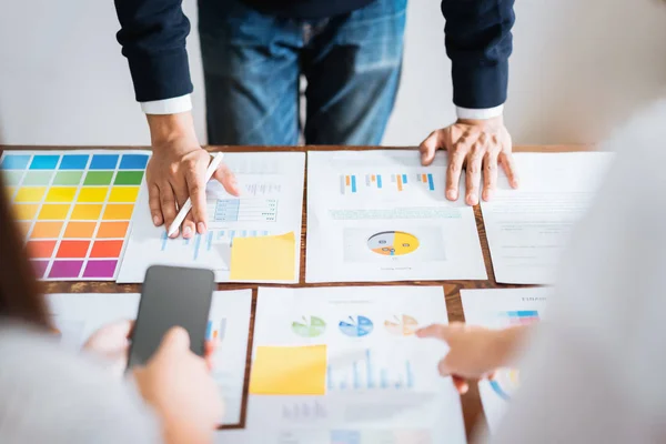 Business people meeting team working on wooden desk and hand  man pointing to financial documents in office. successful meeting workplace strategy.