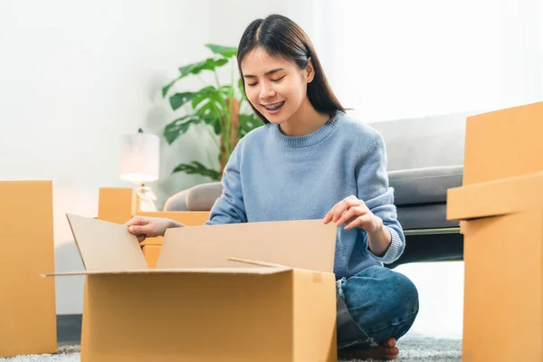 Young Asian woman pack the product and send to the customer.