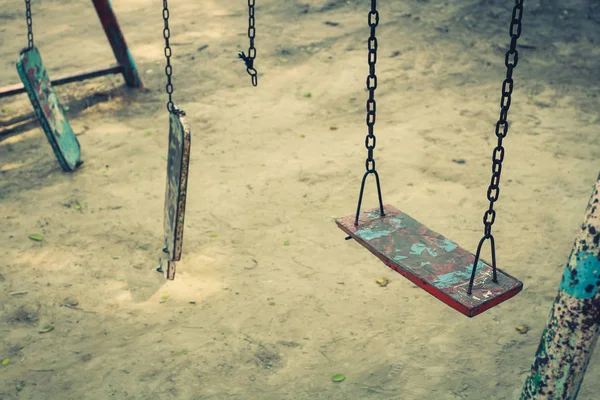Broken chain swing playground in school.