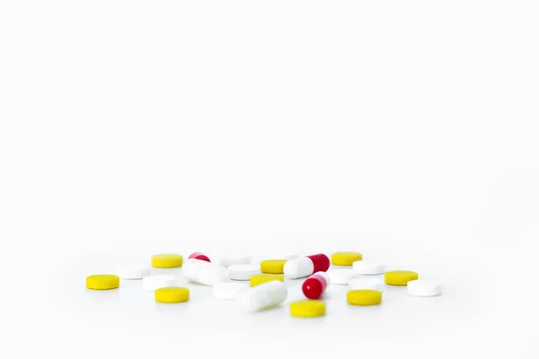 Multicolored Medicines Pills Scattered White Table White Yellow Red Capsules Royalty Free Stock Images