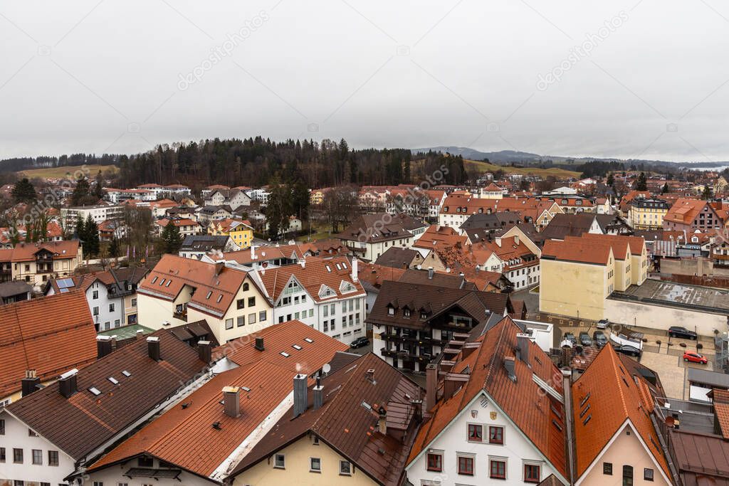 Aerial view of the old town of Fussen on a cloudy winter day from the Hohes Schloss castle, with the Forggensee lake in background, Allgaeu, Bavaria, Germany