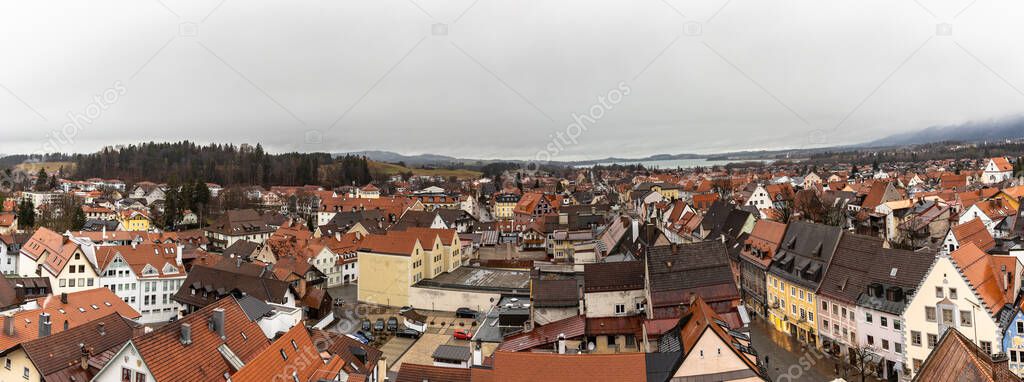 Panorama erial view of the old town of Fussen on a cloudy winter day from the Hohes Schloss castle, with the Forggensee lake in background, Allgaeu, Bavaria, Germany