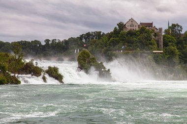 Avrupa 'nın en güçlü şelalesi olan Ren Şelalesi' nin göz kamaştırıcı manzarası. Yüksek Ren Nehri 'nin en güçlü şelalesi. Laufen Kalesi' nin arka planında Schaffhausen, İsviçre