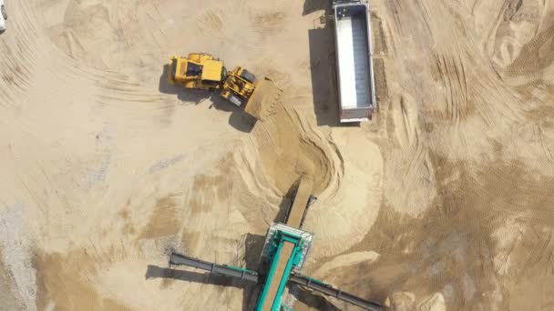 Aerial view loading bulldozer in open air quarry. Sand mining industry. Bulldozer machine. Crawler bulldozer moving at sand mine. Mining machinery working at sand quarry. Drone view of mining equipmen — Stock Video