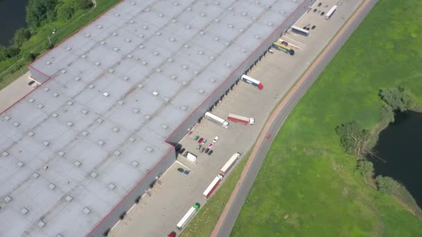 Big Distribution Warehouse Gates Loads Trucks Reversing Loading Dock Aerial — Stock Video