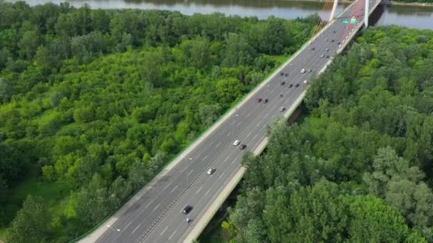 Aerial shooting from flying drone car traffic on modern highway bridge over river — Stock Video