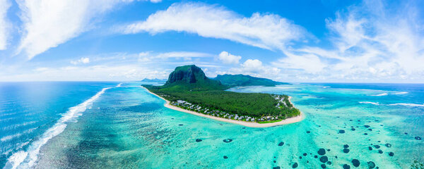 Luxury beach with Le Morne mountain in Mauritius. Beach with palms and blue ocean. Aerial view.  Mauritius island panorama