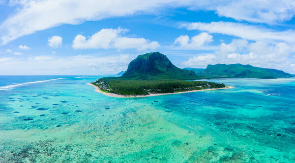 Aerial panoramic view of Mauritius island - Detail of Le Morne Brabant mountain with underwater waterfall perspective optic illusion - Wanderlust and travel concept with nature wonders on vivid filter