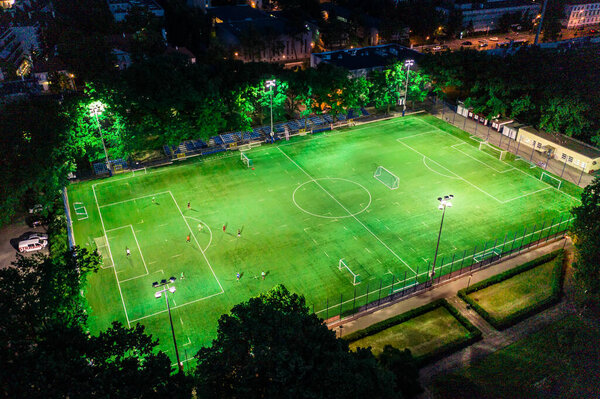 Evening football stadium in evening, aerial view from drone