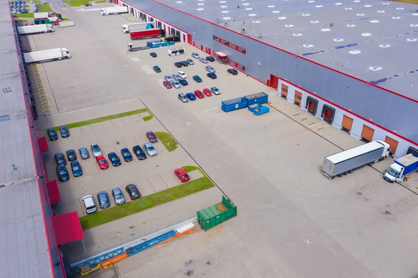 Aerial view of warehouse storages or industrial factory or logistics center from above. Aerial view of industrial buildings and equipment at sunset, toned