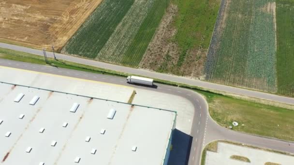 Luftaufnahme einer Verladestation für Industrielager, auf der viele LKW mit Sattelaufliegern Waren beladen. — Stockvideo