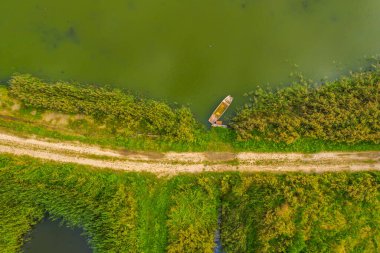Göl kıyısındaki küçük kayığın yukarıdan aşağıya bakan görüntüsü.