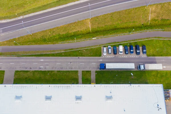 Aerial drone view of group of large modern industrial warehouse or factory buildings in suburban city area.Logistic transportation cargo terminal