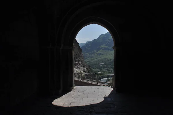 Old rock town in Vardzia, Georgia. The niches of the church and living quarters carved in a rock wall.