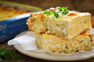 Bulgarian pie Banitsa with cheese. Wooden background clipart
