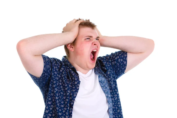 Closeup portrait of angry, frustrated young man, pulling his hair out, isolated on white background. Negative emotions