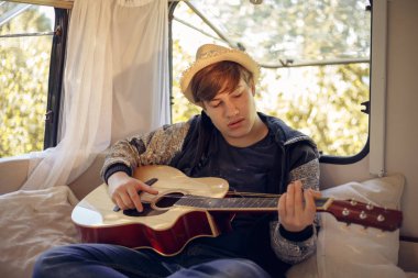 Kamp minibüsü bir gitar ile genç yolcusu.