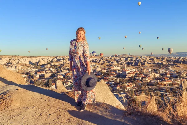 Girl at dawn watching the balloons and enjoying life.