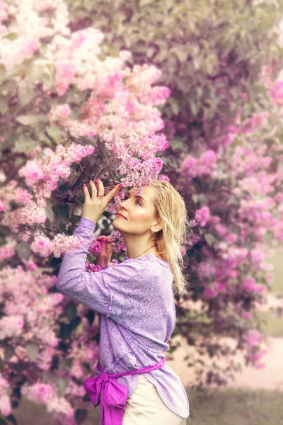 Schöne blonde Frau im blühenden Garten. — Stockfoto